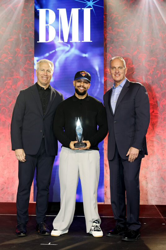 (L-R) Mike Steinberg, BMI Executive Vice President, Chief Revenue & Creative Officer, MAG, BMI Contemporary Latin Songwriter of the Year Award Winner and Mike O'Neill, BMI CEO pose onstage during the 2026 BMI Latin Awards on March 19, 2026 in Miami, Florida. (Photo by Alexander Tamargo/Getty Images)