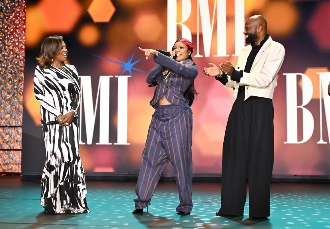 (L-R) Catherine Brewton, VP, Creative, BMI, GloRilla, winner of BMI Impact Award, and Wardell Malloy, Assistant VP, Creative, BMI onstage during the 2025 BMI R&B/Hip-Hop Awards at Fairmont Century Plaza on August 28, 2025 in Los Angeles, California. (Photo by Lester Cohen/Getty Images for BMI)